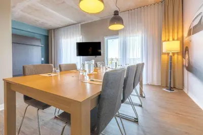 a dining room with a wooden table and chairs at Quality Inn & Suites in Victoriaville