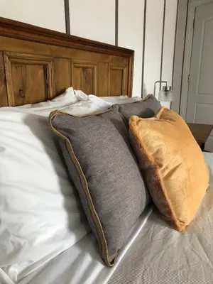 two pillows sitting on top of a bed at AUBERGE Knowlton in Lac-Brome