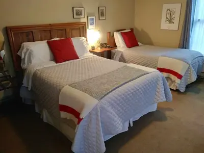 a hotel room with two beds with red pillows at AUBERGE Knowlton in Lac-Brome