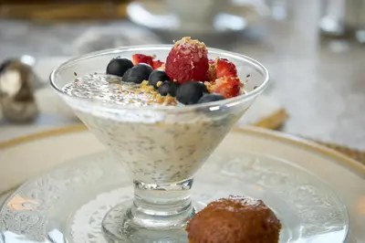 a dessert in a glass bowl on a plate with a treat at Auberge Aux Deux Pères in Magog-Orford