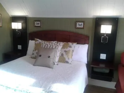 a bedroom with a bed with white sheets and pillows at Le Gîte Du Coteau in Lyster