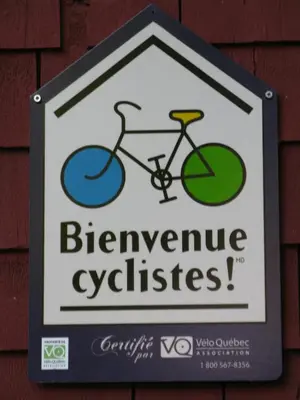 a sign on a wall that reads bicyclecycles at Le Gîte Du Coteau in Lyster