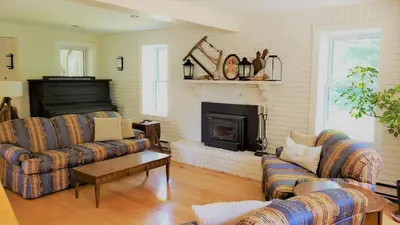 a living room with two couches and a fireplace at Auberge du Vignoble Bromont in Bromont
