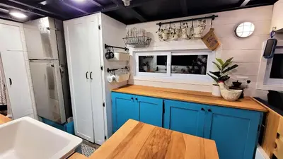 a kitchen with blue cabinets and a sink at Auberge du Vignoble Bromont in Bromont