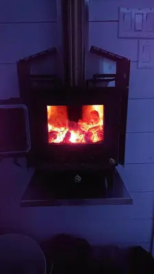a oven with a fire inside of it at Auberge du Vignoble Bromont in Bromont