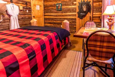 a bedroom with a bed and a table and a chair at Domaine de La Giroux-ette in La Patrie