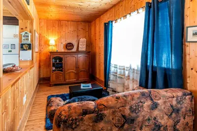 a living room with a couch and a window at Domaine de La Giroux-ette in La Patrie