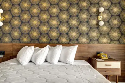 a bedroom with a bed and a wall mural at Hôtel Uville Montréal in Montréal