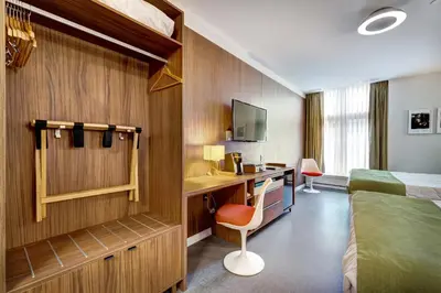 a hotel room with a bed and a desk with a computer at Hôtel Uville Montréal in Montréal