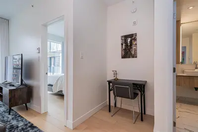 a room with a desk and a bed and a mirror at Le Se7t Penthouses in Montréal