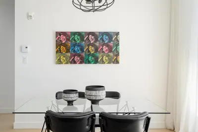 a dining room with a glass table and chairs at Le Se7t Penthouses in Montréal
