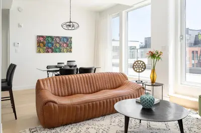 a living room with a couch and a table at Le Se7t Penthouses in Montréal