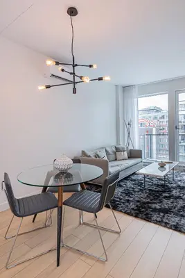 a living room with a table and a couch at Le Se7t Penthouses in Montréal