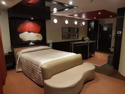 a bedroom with a bed and a chair in it at Le Chabrol Hotel & Suites in Montréal