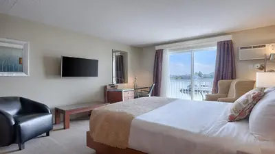a hotel room with a bed and a large window at Auberge Handfield et Spa in Saint-Marc-sur-Richelieu