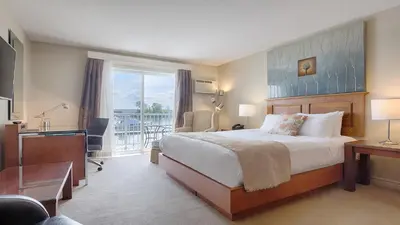 a hotel room with a bed and a balcony at Auberge Handfield et Spa in Saint-Marc-sur-Richelieu