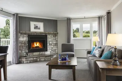a living room with a couch and a fireplace at Auberge West Brome in West Brome