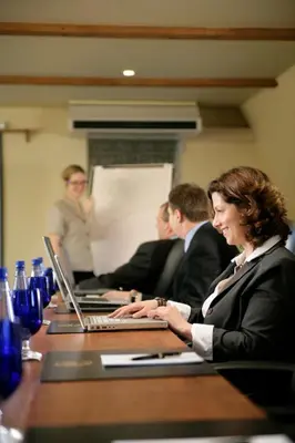 a group of people sitting at a table with laptops at Auberge West Brome in West Brome