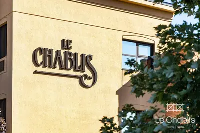 a sign on the side of a building at Hotel Le Chablis Cadillac in Montréal