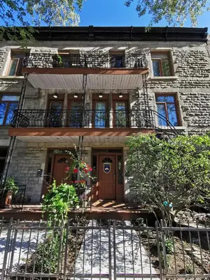 an old brick building with a porch and a balcony at Accueil Chez Francois in Montréal