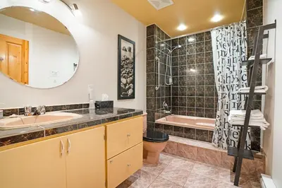 a bathroom with a sink and a tub and a mirror at Accueil Chez Francois in Montréal