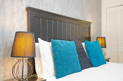 a bedroom with a bed with blue and white pillows at Accueil Chez Francois in Montréal