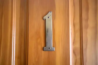 a wooden door with a metal number on it at Accueil Chez Francois in Montréal