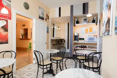 a restaurant with tables and chairs in a room at Hotel Chateau de l'Argoat in Montréal
