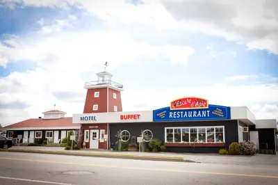 a fast food restaurant with a tower on top of it at Motel le Phare in Plessisville