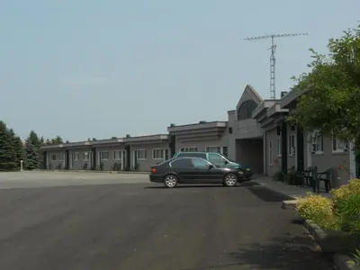 a black car parked in front of a building at Motel Normandie in Louiseville