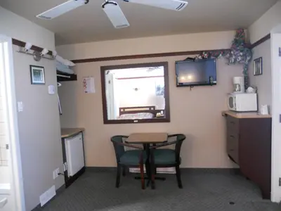 a room with a table and chairs and a window at Motel Normandie in Louiseville