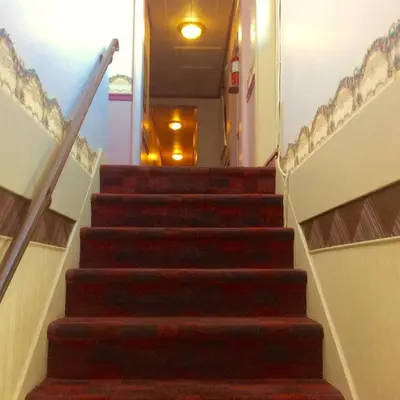 a flight of stairs in a building with a light at Motel Saint-Hilaire in Mont-Saint-Hilaire