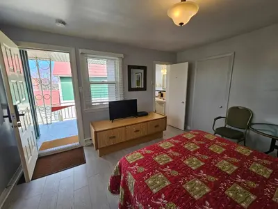 a bedroom with a bed and a television in it at Motel Saint-Hilaire in Mont-Saint-Hilaire