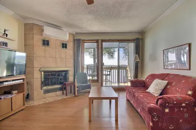 a living room with a red couch and a fireplace at Location Tourisme Estrie - Oberge du Village in Magog-Orford