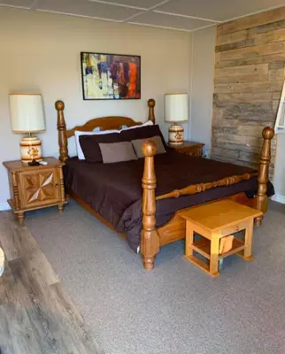 a bedroom with a large bed and two night stands at Le Loft Riverstone CITQ 3O1849 in Saint Pierre de Broughton