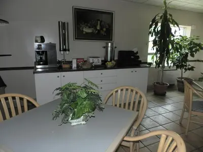 a kitchen with a table with plants on it at L'Auberge de l'Aeroport Inn in Dorval