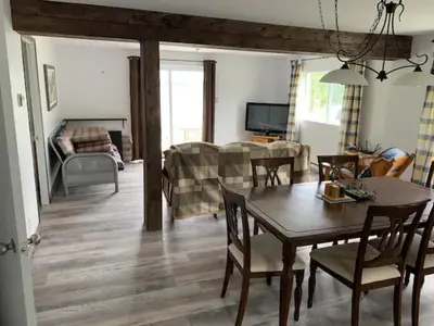 a living room with a table and a couch at La Grange sur le Lac App A et B in Saint Romain