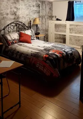 a large bed in a room with a table at Gîte Au p'tit bonheur B&B in Coaticook