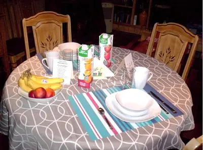 a table with a bowl of fruit and a plate of food at Gîte Au p'tit bonheur B&B in Coaticook