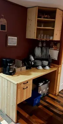 a kitchen with a wooden counter with dishes on it at Gîte Au p'tit bonheur B&B in Coaticook