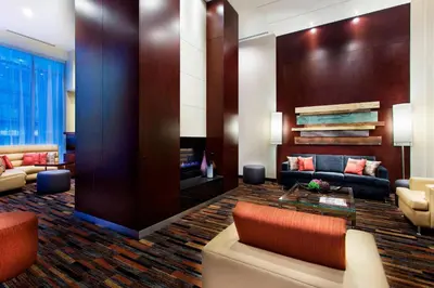 a living room with a couch and a table at Courtyard par Marriott Montréal Centre-ville in Montréal