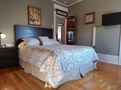 a bedroom with a large bed in a room at Le 100 St-Laurent in Louiseville