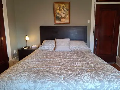 a bedroom with a large bed with a pillow on it at Le 100 St-Laurent in Louiseville