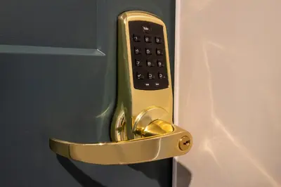 a gold door handle with a remote control in it at Square Victoria Maison Hôtelière in East Angus
