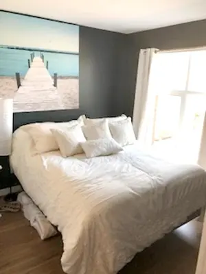 a bedroom with a bed with a view of the beach at Luxurious Apartment in Brossard with Terrace in Brossard