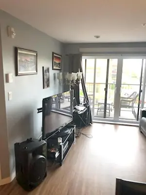 a living room with a flat screen tv at Luxurious Apartment in Brossard with Terrace in Brossard