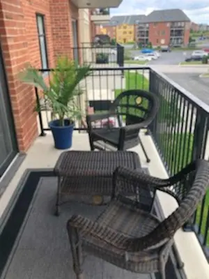 two chairs and a table on a balcony at Luxurious Apartment in Brossard with Terrace in Brossard