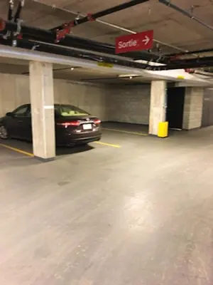 a car is parked in a parking garage at Luxurious Apartment in Brossard with Terrace in Brossard