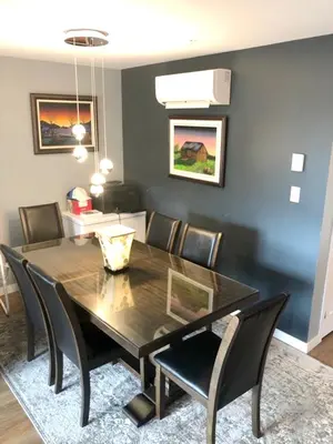 a dining room with a black table and chairs at Luxurious Apartment in Brossard with Terrace in Brossard
