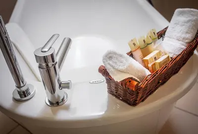 a basket sitting on top of a toilet in a bathroom at Hotel Bonaparte in Montréal